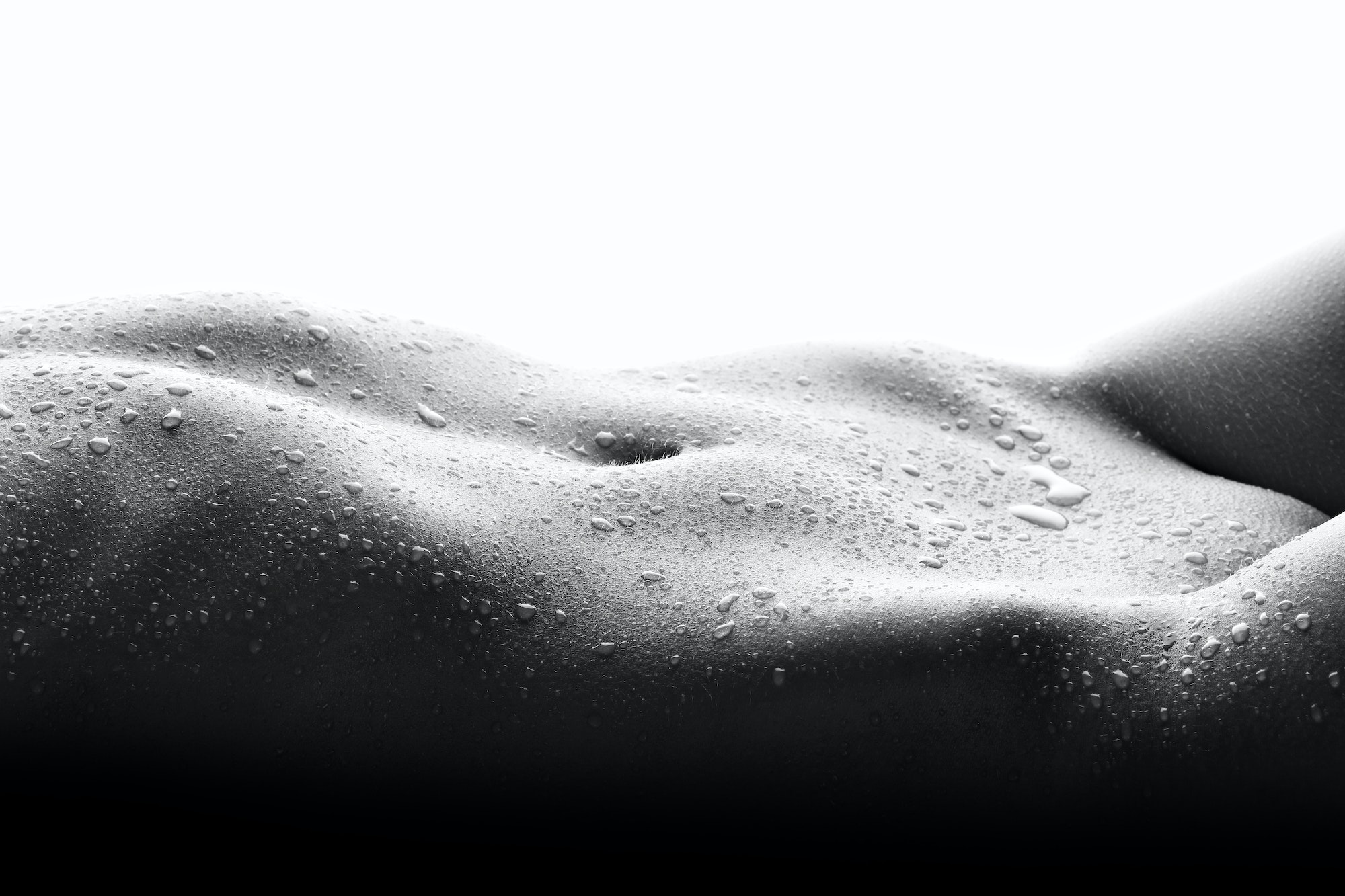 Sensual nude female body with drops of water and with place for text